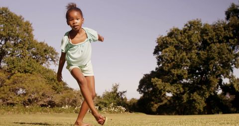 Energetic Young Girl Practicing Acrobatic Moves in Park - Download Free Stock Images Pikwizard.com
