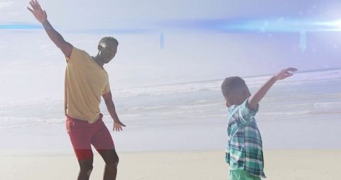 Father Playing Alongside His Son by Beach Under Blue Sky