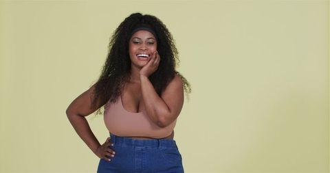 Confident African American Woman Smiling Against Yellow Background