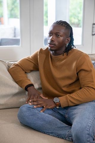 Man in Cozy Living Room Relaxing on Sofa