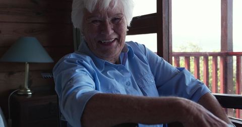 Active Senior Woman Smiling in Wheelchair at Cozy Home