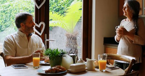 Middle-Aged Couple Enjoying Relaxed Breakfast at Home