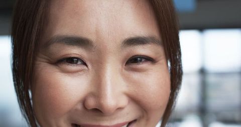 Middle-aged Asian Woman Smiling with Warm Expression