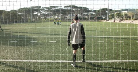 Soccer Goalkeeper Awaiting Penalty Kick Against Sunny Field Vista