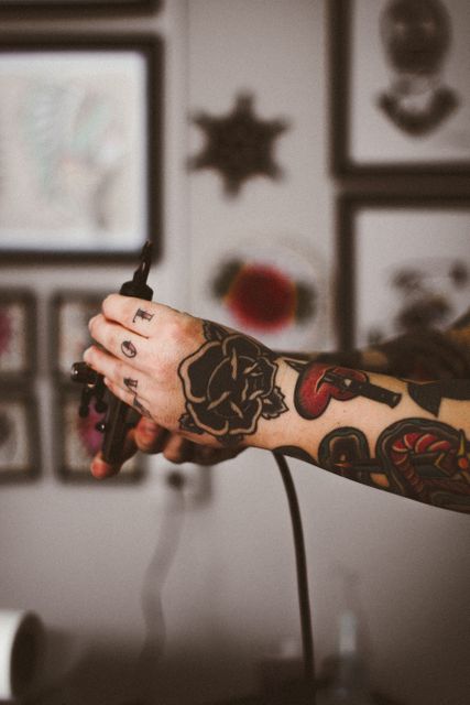 This visual can be used in articles or advertisements about tattooing, showcasing skills of tattoo artists or artistic process. It is an excellent choice for promoting tattoo studios, ink brands, creative works, or anything related to body art lifestyle.