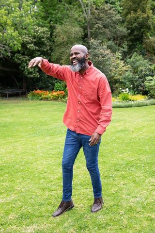 Senior Man Enjoying Leisure in Lush Garden