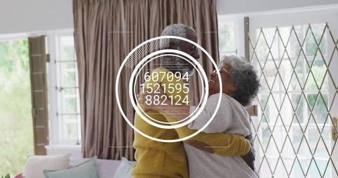 Senior Mother and Adult Son Sharing Joyful Hug at Home