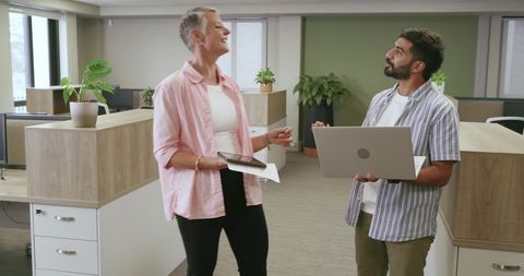Diverse coworkers collaborating in modern open office environment