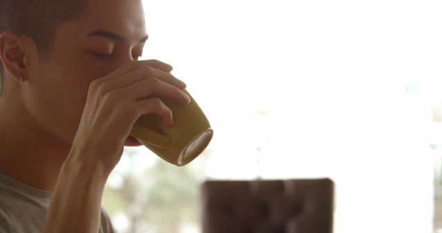 Young man enjoying morning coffee in cozy setting - Download Free Stock Images Pikwizard.com