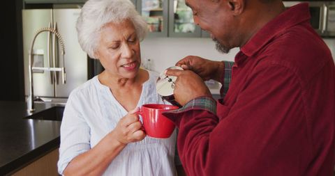 Senior Couple Enjoying Coffee Together in Cozy Kitchen Moment