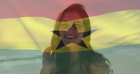Smiling woman on beach with ghana flag overlay celebrating travel and national pride