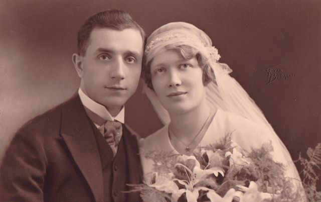 Shows a vintage wedding portrait featuring a bride and groom in formal attire. Beautiful fit for historical archives, wedding theme collections, or retro decorations.