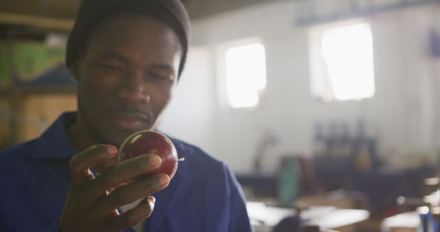 Worker Examining Red Apple in Industrial Workshop - Download Free Stock Images Pikwizard.com