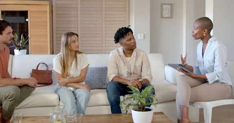 Diverse group discussing ideas in cozy living room
