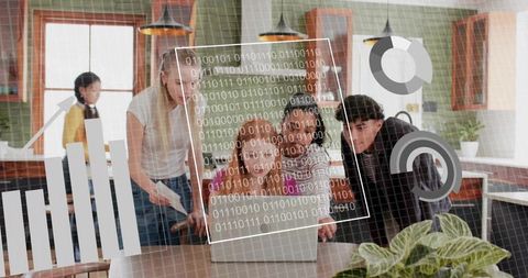 Casual team collaborating on laptop with data visualization overlays in modern kitchen