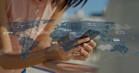 Holding smartphone with holographic world map overlay delivering mobile data analytics