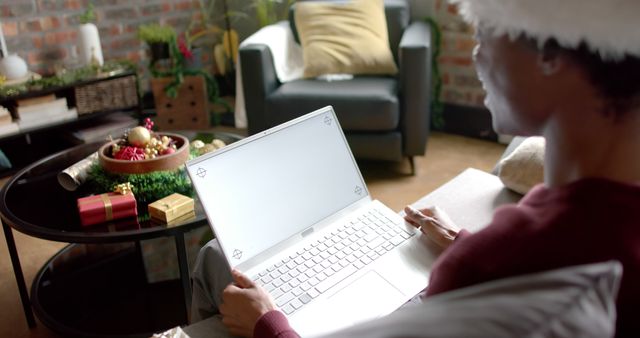 Person Shopping Online for Christmas Gifts on Laptop At Home - Download Free Stock Images Pikwizard.com