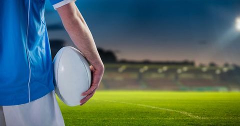 Focused Rugby Player Holding Ball on Stadium Field - Download Free Stock Images Pikwizard.com