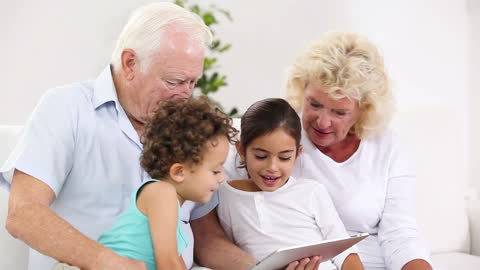 Grandparents and Grandchildren Enjoying Tablet Time