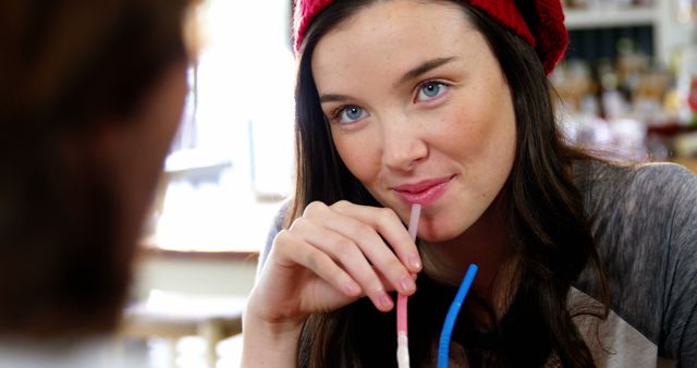 Woman Drinking Beverage with Straw in Cozy Cafe - Download Free Stock Images Pikwizard.com