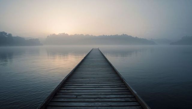 Misty lake dock at dawn evoking tranquil serenity