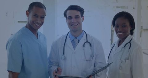 Diverse medical team collaborating in modern hospital corridor