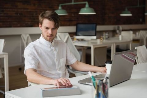 Man Working in Modern Co-Working Space with Laptop