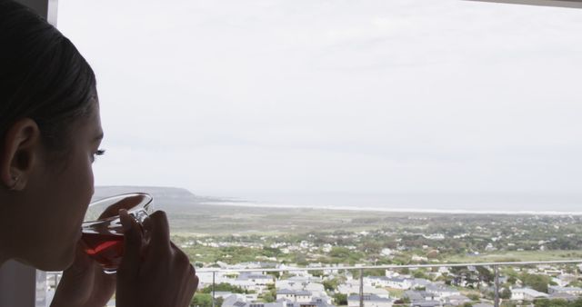 Woman Enjoying Tea with Scenic Coastal View - Download Free Stock Images Pikwizard.com