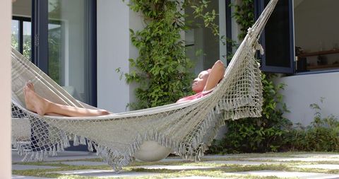 Young Woman Relaxing in Hammock Outside Modern Home - Download Free Stock Images Pikwizard.com