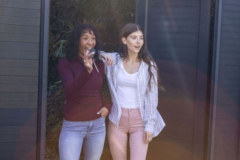 Diverse friends with car keys socializing outdoors