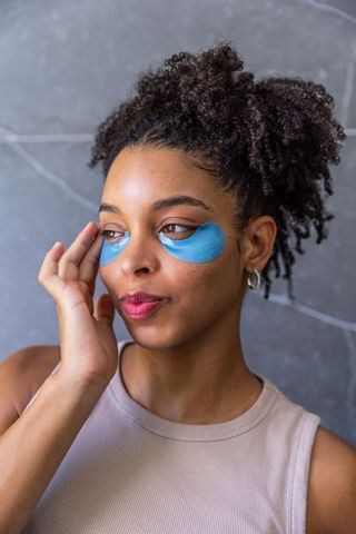 African american woman wearing blue under-eye hydrogel patches, skincare self-care portrait