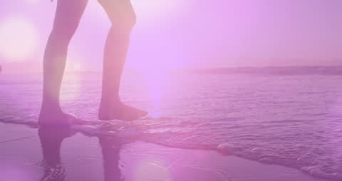 Caucasian Woman Walking in Water at Beach with Optical Light Spots