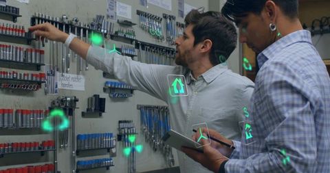 Technicians using tablet and ar overlays to select sockets on organized tool wall