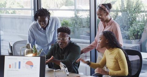 Diverse Professional Team Excitedly Collaborating on Business Project