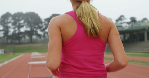 Female Athlete on a Running Track, Focused and Determined