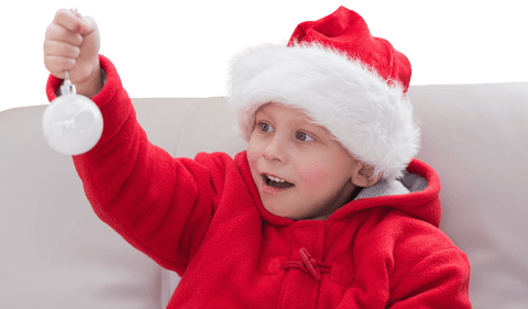 Joyful Boy in Santa Hat Holding Christmas Bauble, Transparent Background
