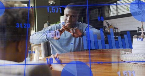 Gesturing man crossing hands at table with child, digital data overlay for mentoring