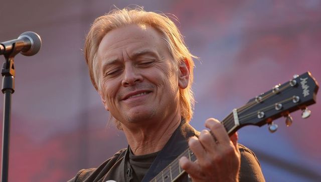 Mature Musician Strumming Acoustic Guitar