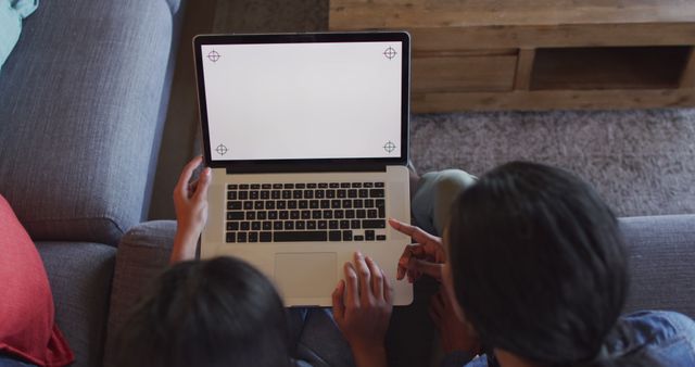 Top View of People Using Laptop with Blank Screen in Living Room - Download Free Stock Images Pikwizard.com