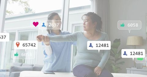 Home physical therapy session with caregiver guiding arm stretch while tracking progress