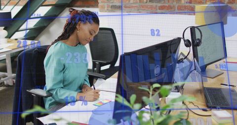 Statistical Data Overlay on Professional African American Woman in Office