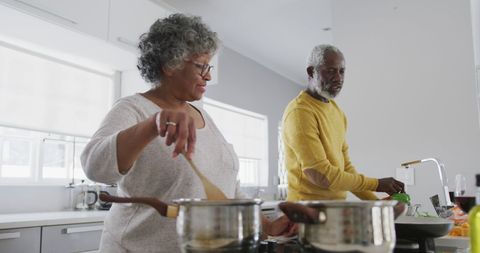 Senior African American Couple Cooking in Modern Kitchen Setting