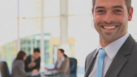 Confident Businessman Smiling in Modern Office Setup