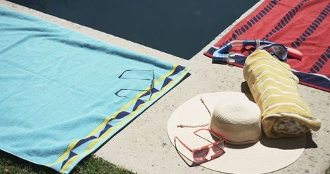Summer Poolside Leisure with Towels, Hat, and Sunglasses - Download Free Stock Images Pikwizard.com