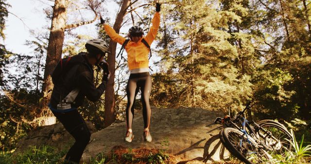 Joyful Cyclists Jumping on Forest Rock Trail - Download Free Stock Images Pikwizard.com