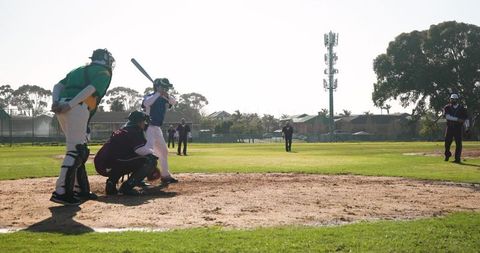 Amateur baseball game outdoor batting action sunny park