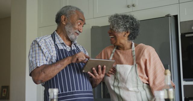 Happy Elderly Couple Cooking Together While Using Digital Tablet in Kitchen - Download Free Stock Images Pikwizard.com