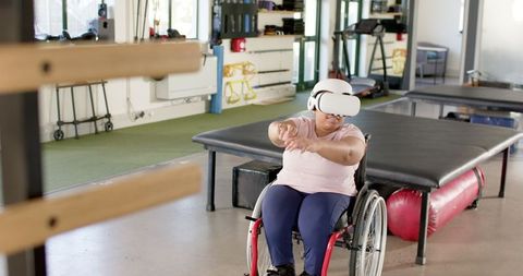 Paraplegic Woman Using VR Headset for Rehabilitation Exercise