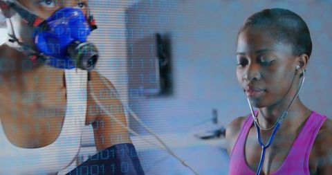 Clinician listening with stethoscope as patient wearing respiratory mask and blood pressure cuff
