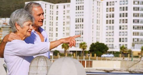 Smiling Senior Couple Enjoying Leisure Time by Seaside